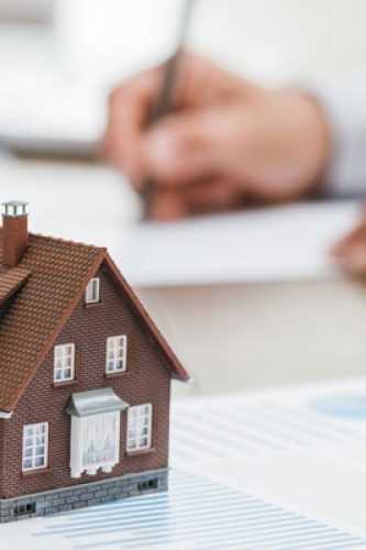 real-estate-agent-working-in-his-office-P68S2PN real-estate-agent-working-in-his-office-P68S2PN